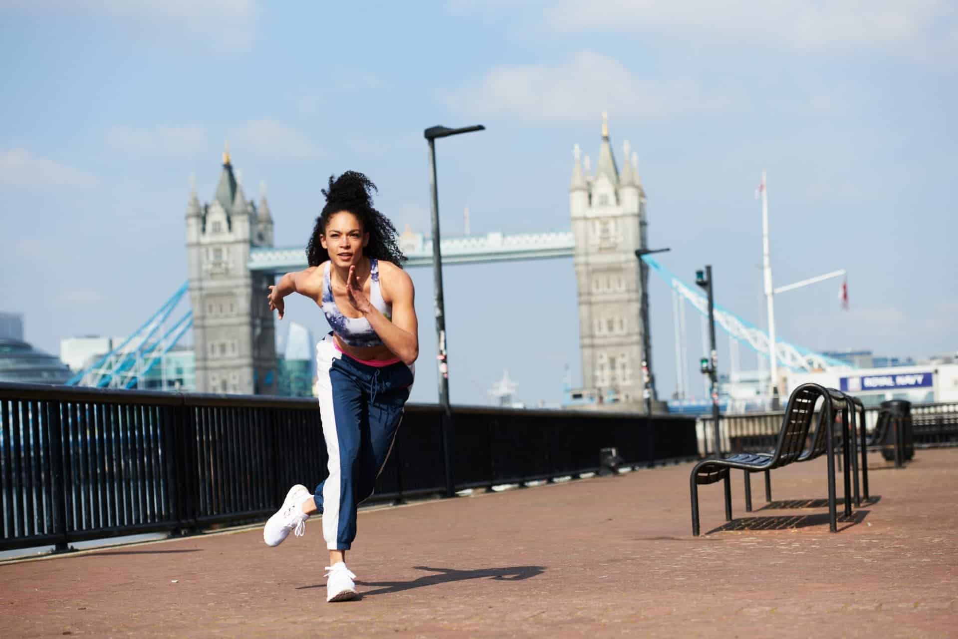 Hannah Dominic Marley Peloton instructor exercising in front of London Bridge, London